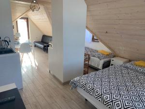 a bedroom with a bed and a desk in a room at Noclegi Zakopane Krzesanica in Zakopane
