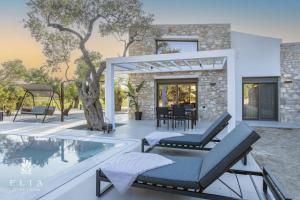 a villa with a swimming pool and a house at ELIA STONE VILLAS in Skala Prinou