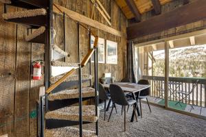 a spiral staircase in a cabin with a table and chairs at Townhome with Mtn View - Walk to Brian Head Lifts! in Brian Head
