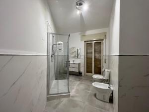 a bathroom with a shower and a toilet and a sink at Holiday House Catania in Catania