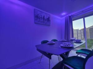 a purple dining room with a table and chairs at Tyburn Home, Birmingham with FREE Parking in Birmingham