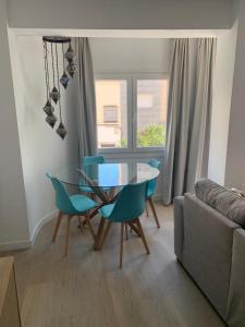 a living room with a glass table and chairs at Piso Calle Murcia in Almería
