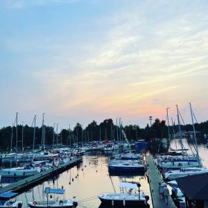 a group of boats docked in a marina at sunset at Dom Na Wodzie in Węgorzewo