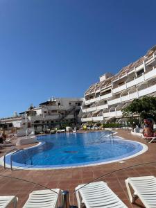 a large swimming pool in front of a building at Appartamento Costa adeje, Puerto colonn in Adeje