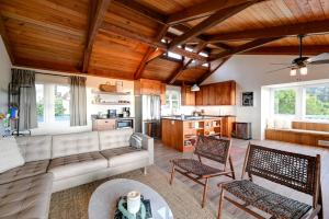 a living room with a couch and chairs at Hot Tub and Ocean Views Spacious Irish Beach Home! in Manchester