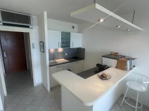 a kitchen with a white counter top in a room at Superbe Pieds dans l eau ajaccio face à la mer plage de sable fin route des îles des sanguinaires in Ajaccio