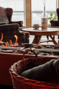 a basket with a fire in a living room at Malangen Resort in Mestervik