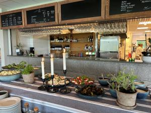 a buffet line with food and candles in a restaurant at Sotenäs Golfhotell in Hunnebostrand