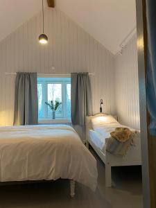 a bedroom with two beds and a window at Storsand Gård in Trondheim