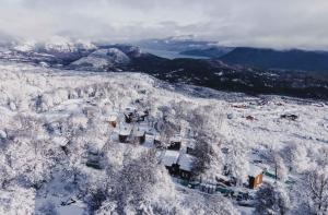 an aerial view of a town covered in snow at El Refugio Ski & Summer Lodge in San Martín de los Andes