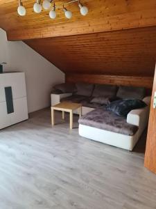 a living room with a couch and a table at appartement 3 pce in Vicques
