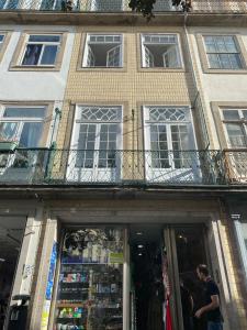 a man standing in front of a building at Casa Augusta 3 in Braga