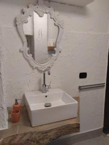 a bathroom with a white sink and a mirror at LANZO IN CORTE APPARTAMENTO in Lanzo dʼIntelvi +31 photos
