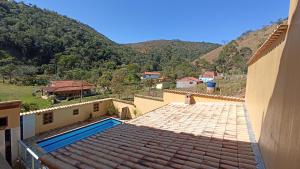 クーニャにあるPousada Alejandroのスイミングプール付きの家屋の屋根からの眺め