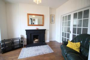 a living room with a couch and a fireplace at City Centre Townhouse in Galway