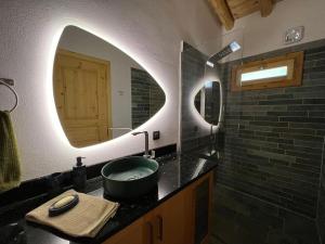 a bathroom with a sink and a mirror at Luxury Historic Island Home with Private Garden in Poros
