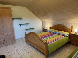 a bedroom with a wooden bed and shelves on the wall at Hadassa Apartment Simcha in Niederwichtrach