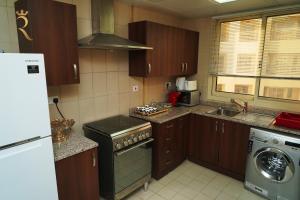 A kitchen or kitchenette at Your Serene Getaway Haven Azure Baniyas 1BR Apartment