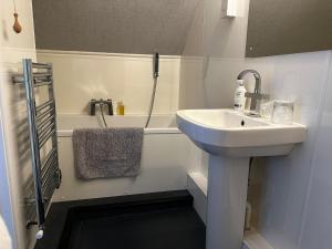 a bathroom with a sink and a bath tub at Headlands - Room Only Accommodation in Falmouth