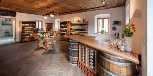 una sala de cata de vinos con un bar con botellas de vino en Posthansl l Sernau 1, en Gamlitz