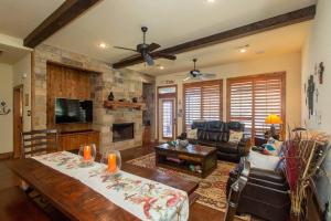 a living room with a table and a fireplace at Luxurious, Tranquil, 4BR Lakefront Villa in Mabank