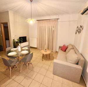 a living room with a couch and a table at 22 Apartment with private parking in Larisa
