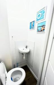 a bathroom with a toilet and a sink at Ursus Rooms-Self Check-in in Warsaw