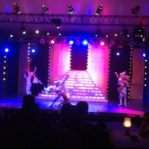 a group of people dancing on a stage with lights at Suite Elisir Domina Coral Bay in Sharm El Sheikh