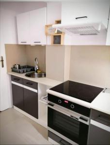 a small kitchen with a stove and a sink at Ursus Rooms-Self Check-in in Warsaw