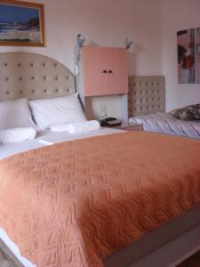 a bedroom with a large bed with a wooden headboard at La Santre Villa in Amoudara Herakliou