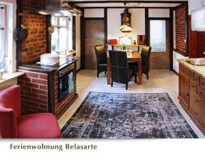 a kitchen with a table and a dining room at Ferienwohnung Belasarte in Bad Elster
