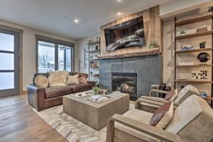 a living room with a fireplace and a couch at Winter Park Condo w/Hot Tub & 4 Mi to Skiing in Winter Park