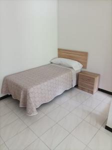 a small bedroom with a bed and a wooden cabinet at El Ferial in Sarón +13 photos