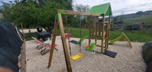 a playground with a slide and a swing set at -SKY- Appartement meublé cosy & confort-Parking privé & jardin in Laveyron