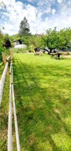 a wooden fence in a field with a park at -WOOD- Appartement meublé cosy & confort-Parking privé & jardin in Laveyron
