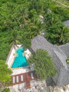an overhead view of a swimming pool next to a house at Natural Garden Hotel in Jambiani