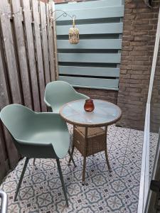 Dos sillas y una mesa en un patio. en zomerhuis in Wijk aan Zee! 2 pers, en Wijk aan Zee 7 fotos más