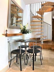 a dining room table with chairs and a mirror at Prime Location! Detached Clifton Home with Parking in Bristol