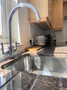 a kitchen sink with a faucet in a kitchen at Prime Location! Detached Clifton Home with Parking in Bristol