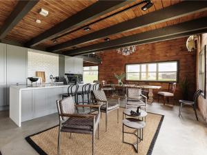 a kitchen and dining room with chairs and a table at Laxá Lodge in Hella