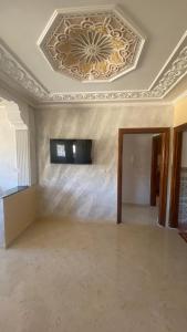 a room with a ceiling with a television on it at Big appartement in ksar sgher and close in Ksar es Sghir
