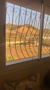 a window with a view of a field of grass at Big appartement in ksar sgher and close in Ksar es Sghir