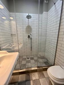 a bathroom with a shower with a toilet and a sink at Hygge in Tatariv