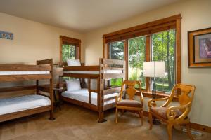 a bedroom with bunk beds and a desk and chairs at The Porches in Steamboat Springs