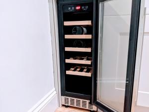 a wine cabinet with wine bottles in it at No.12 In The Heart Of Blackpool in Blackpool