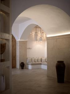 a living room with a white couch in an archway at Lesante Cape Resort & Villas - The Leading Hotels of the World in Akrotiri