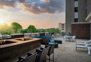 a patio with chairs and a fire pit on a building at SpringHill Suites by Marriott Pittsburgh Mt. Lebanon in Mount Lebanon