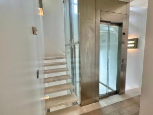 a staircase in a building with a glass door at Villa Don Juan in San Sebastián