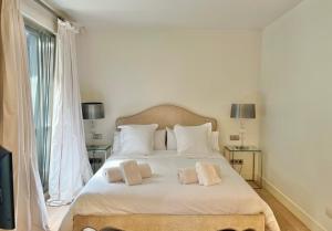 a bedroom with a white bed with two pillows at Villa Don Juan in San Sebastián