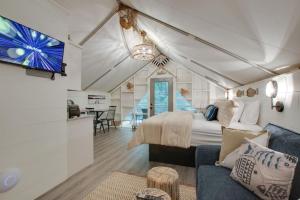 a bedroom with a bed and a living room at 7 Fishing Lure Luxury Glamping Tent Fishing Theme in Scottsboro